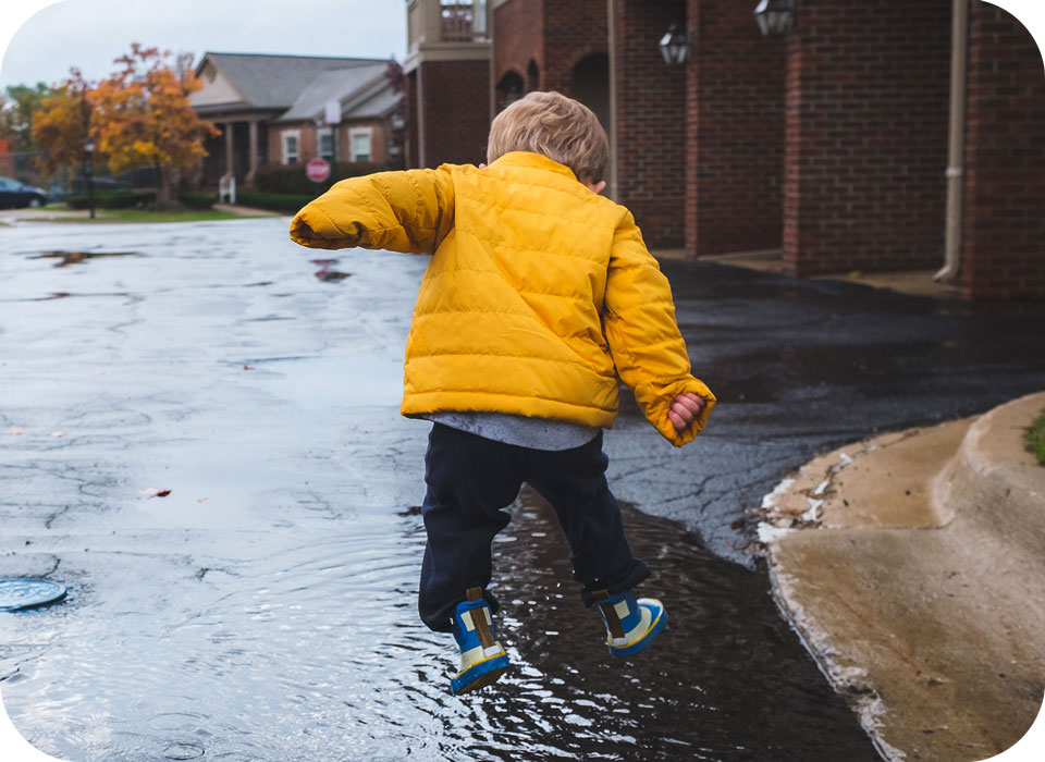 Kid Jumping In Puddle